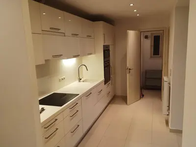 a kitchen with white cabinets and a sink at Spacious Rooms in Prague 6 near center in Prague