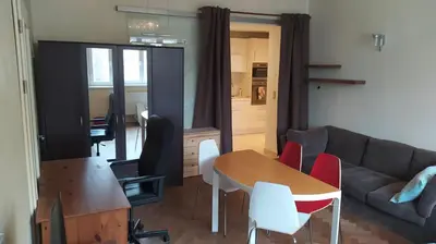 a living room with a couch and a table and chairs at Spacious Rooms in Prague 6 near center in Prague