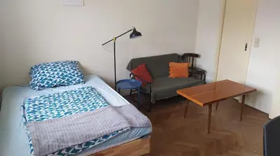 a bedroom with a bed and a chair and a table at Spacious Rooms in Prague 6 near center in Prague