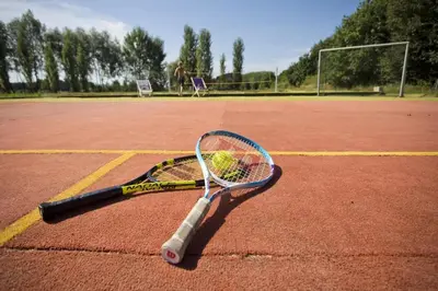 a tennis racket laying on a tennis court at RESORT SALIXA u Poděbrad in Poděbrady