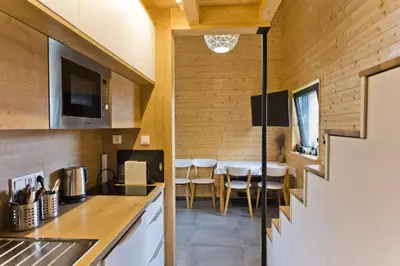 a kitchen and dining room in a tiny house at RESORT SALIXA u Poděbrad in Poděbrady
