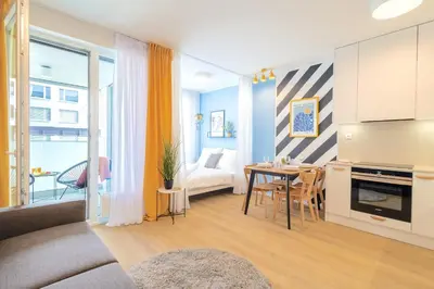 a living room with a couch and a dining room at Yellow Apartment - Balcony, Free Parking, by Gravity Prague in Prague