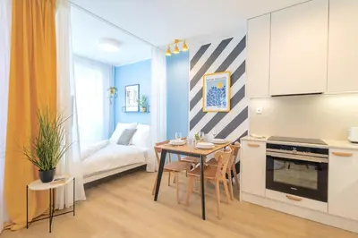 a small apartment with a table and a couch at Yellow Apartment - Balcony, Free Parking, by Gravity Prague in Prague