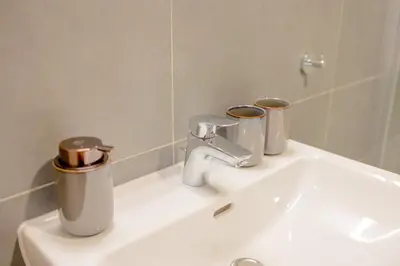 a bathroom sink with two trash cans on it at Yellow Apartment - Balcony, Free Parking, by Gravity Prague in Prague