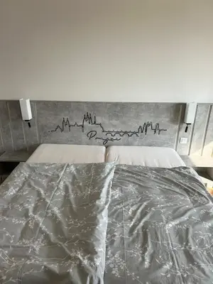a bedroom with a bed with a painting on the wall at Prague Smíchov Anděl Apartment in Prague
