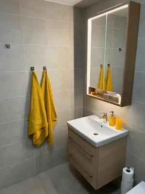 a bathroom with a sink and a mirror at Prague Smíchov Anděl Apartment in Prague
