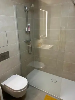 a bathroom with a shower and a toilet at Prague Smíchov Anděl Apartment in Prague