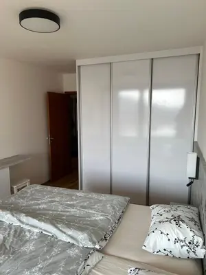 a bedroom with a bed and a large closet at Prague Smíchov Anděl Apartment in Prague