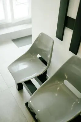 a white chair sitting next to a toilet in a room at Godiland Apartment in Prague
