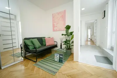 a living room with a couch and a potted plant at Godiland Apartment in Prague