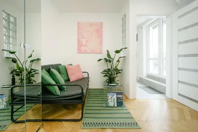 a living room with a couch and a rug at Godiland Apartment in Prague
