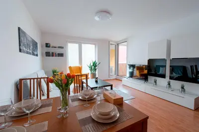 a living room with a table and a dining room at Apartmán u METRA, 4 hosté, parking free, blízko O2 arena in Prague
