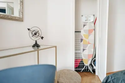 a room with a blue chair and a surfboard at Royal Heritage Apartments - City Centre in Prague