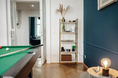 a living room with a pool table and blue walls at Royal Heritage Apartments - City Centre in Prague
