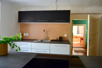a kitchen with white cabinets and a sink at Karlštejn 34 in Karlštejn