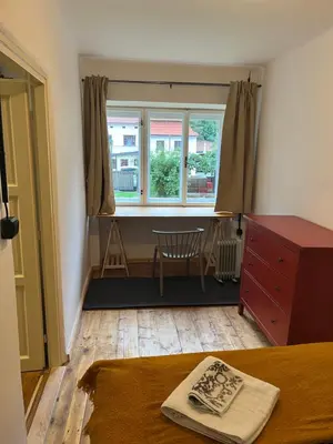 a bedroom with a bed and a window and a desk at Karlštejn 34 in Karlštejn