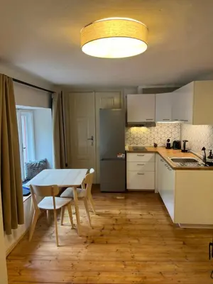 a small kitchen with a table and a refrigerator at Karlštejn 34 in Karlštejn