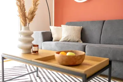 a bowl of fruit on a coffee table in front of a couch at Stylish Apartment - Free Parking, Cinema, by Gravity Prague in Prague