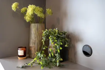 two vases with flowers are sitting on a table at Stylish Apartment - Free Parking, Cinema, by Gravity Prague in Prague