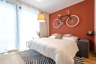 a bedroom with a bed with a bike on the wall at Stylish Apartment - Free Parking, Cinema, by Gravity Prague in Prague