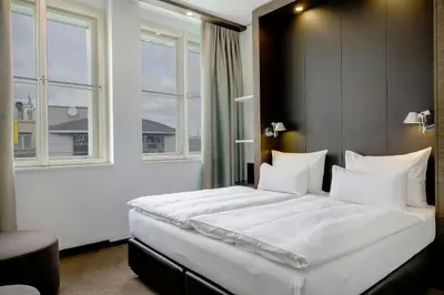 a dining room with a table and chairs at Motel One Prague-Florentinum in Prague
