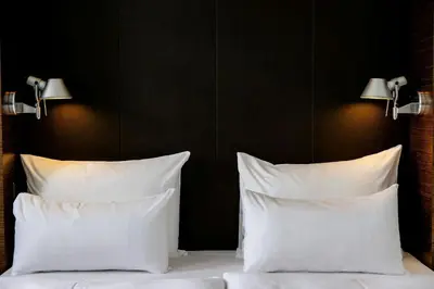 a bedroom with a large bed with white sheets and pillows at Motel One Prague-Florentinum in Prague