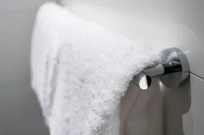 a close up of a shower head with white towel at Motel One Prague-Florentinum in Prague