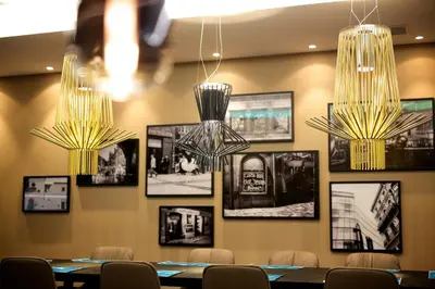 a restaurant with tables and chairs and a wine glass at Motel One Prague-Florentinum in Prague