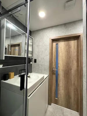 a bathroom with a sink and a wooden door at Smarty Choice Living with FREE PARKING - Vondroušova in Prague