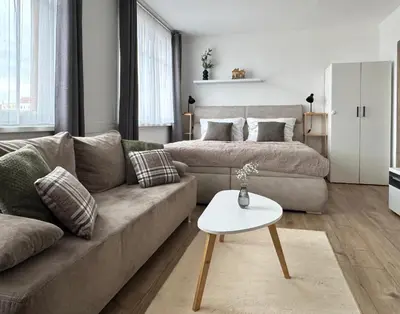 a large bed in a bedroom with a large window at Smarty Choice Living with FREE PARKING - Vondroušova in Prague