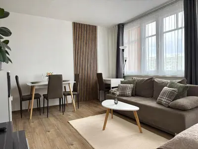 a living room with a couch and a table at Smarty Choice Living with FREE PARKING - Vondroušova in Prague