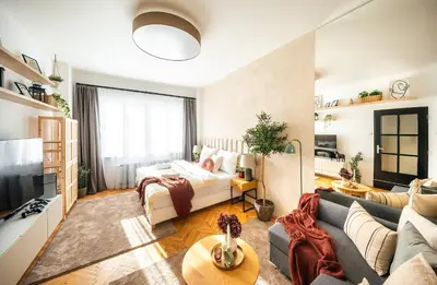 a living room with a couch and a tv at 2BR 1,5Bath Chic City Suite near Wenceslas Square in Prague