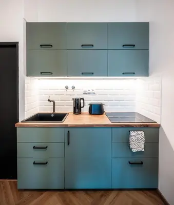 a kitchen with blue cabinets and a sink at 2BR 1,5Bath Chic City Suite near Wenceslas Square in Prague