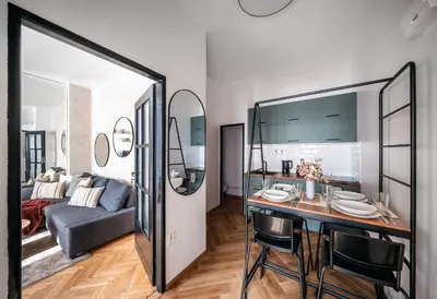 a living room with a table and a couch at 2BR 1,5Bath Chic City Suite near Wenceslas Square in Prague