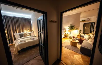 a bedroom with a bed and a living room at 2BR 1,5Bath Chic City Suite near Wenceslas Square in Prague