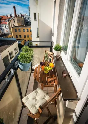 a balcony with a table with a bowl of fruit on it at 2BR 1,5Bath Chic City Suite near Wenceslas Square in Prague