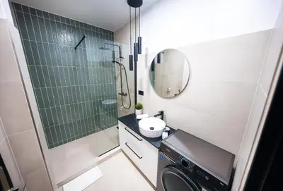 a bathroom with a washing machine and a shower at 2BR 1,5Bath Chic City Suite near Wenceslas Square in Prague