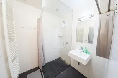 a white bathroom with a sink and a shower at Prague Camping Dzban in Prague