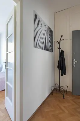 a room with a white wall with a picture on the wall at La Terrasse Apartment Prague center in Prague