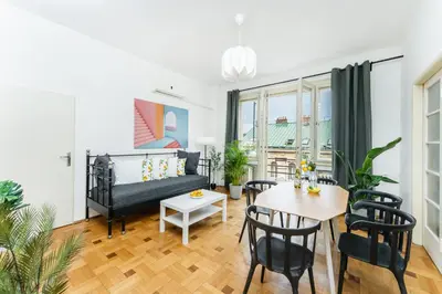 a living room with a bed and a table and chairs at La Terrasse Apartment Prague center in Prague