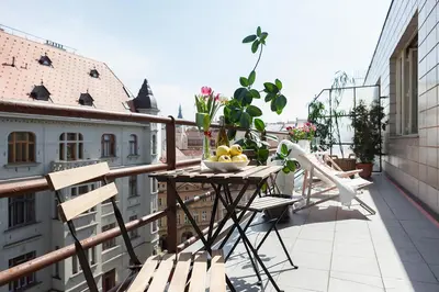 a table with a bowl of fruit on a balcony at La Terrasse Apartment Prague center in Prague