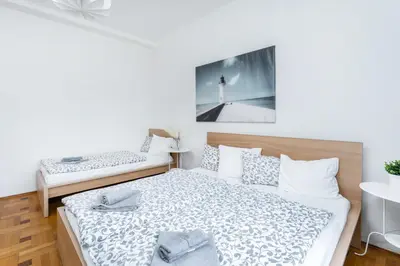 a bedroom with two beds and a picture of a lighthouse at La Terrasse Apartment Prague center in Prague