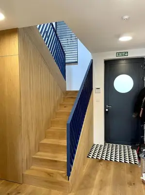 a hallway with a staircase with a blue door at One of the kind Prague Houseboat Experience +BOAT in Prague