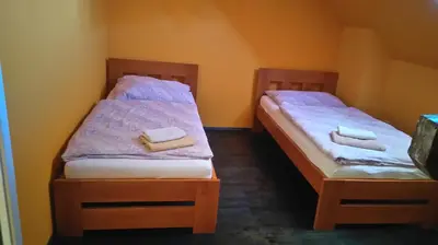 a bedroom with a bed with towels on it at Šestajovický pivovar ubytování in Šestajovice