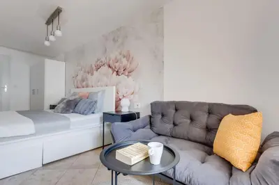 a living room with a couch and a bed at Cozy & Quiet Center Attic with Castle view - vtuB in Prague