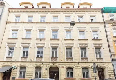 a large building with many windows on a city street at Cozy & Quiet Center Attic with Castle view - vtuB in Prague