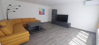 a living room with a couch and a television at Relax apartmán Pod Javorem in Kladno
