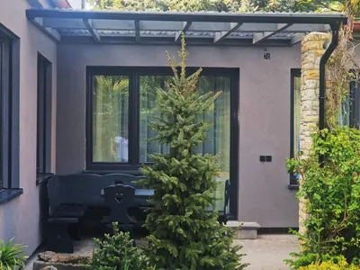 a christmas tree in front of a house at Relax apartmán Pod Javorem in Kladno