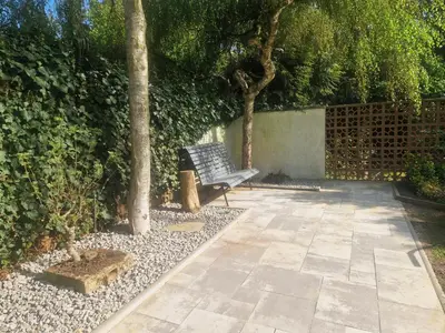 a bench sitting in the middle of a garden at Relax apartmán Pod Javorem in Kladno