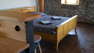 a wooden table with two dishes on top of it at Farma Bláto - Apartmány Sýpka a glamping in Uhlířské Janovice